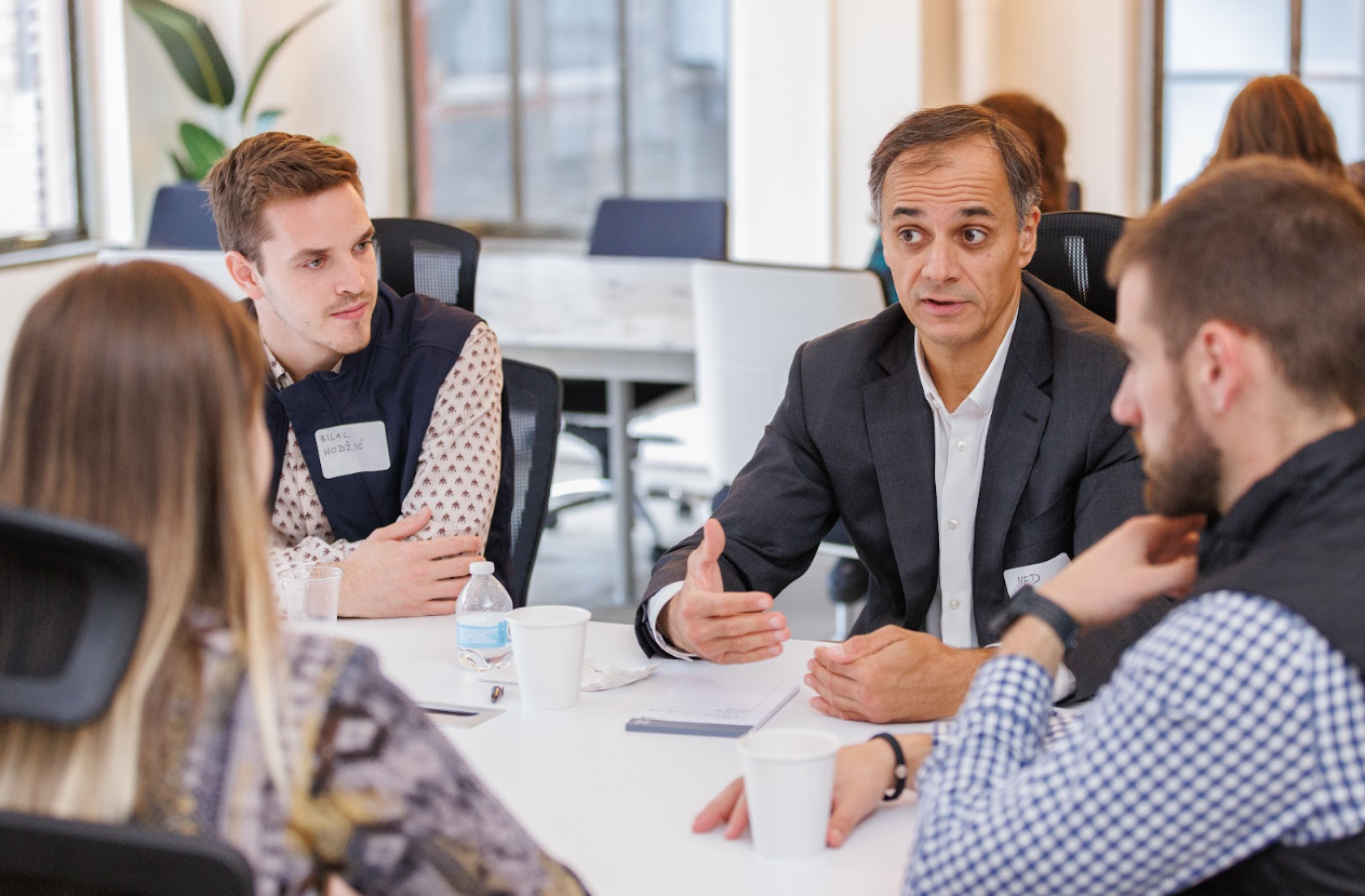 Professionals discuss entrepreneurial ideas in a modern office during a business meeting.