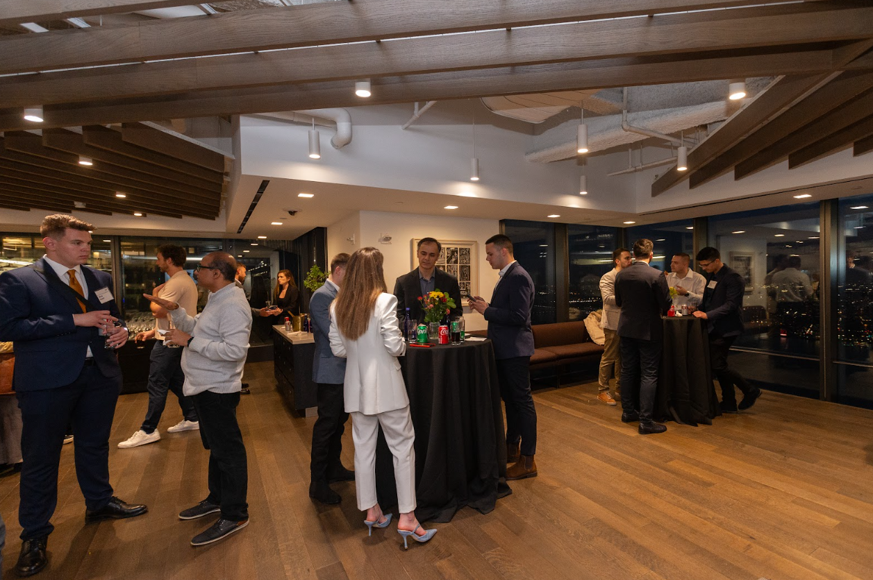 BOLD professionals networking at a social event in a modern office.